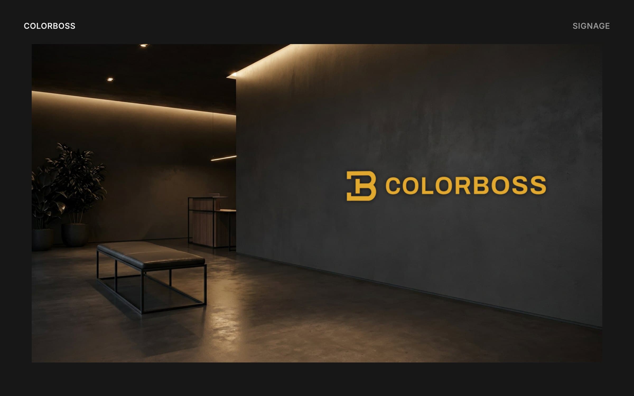 Mockup of a dark reception area with the ColorBoss logo in gold letters on a concrete wall