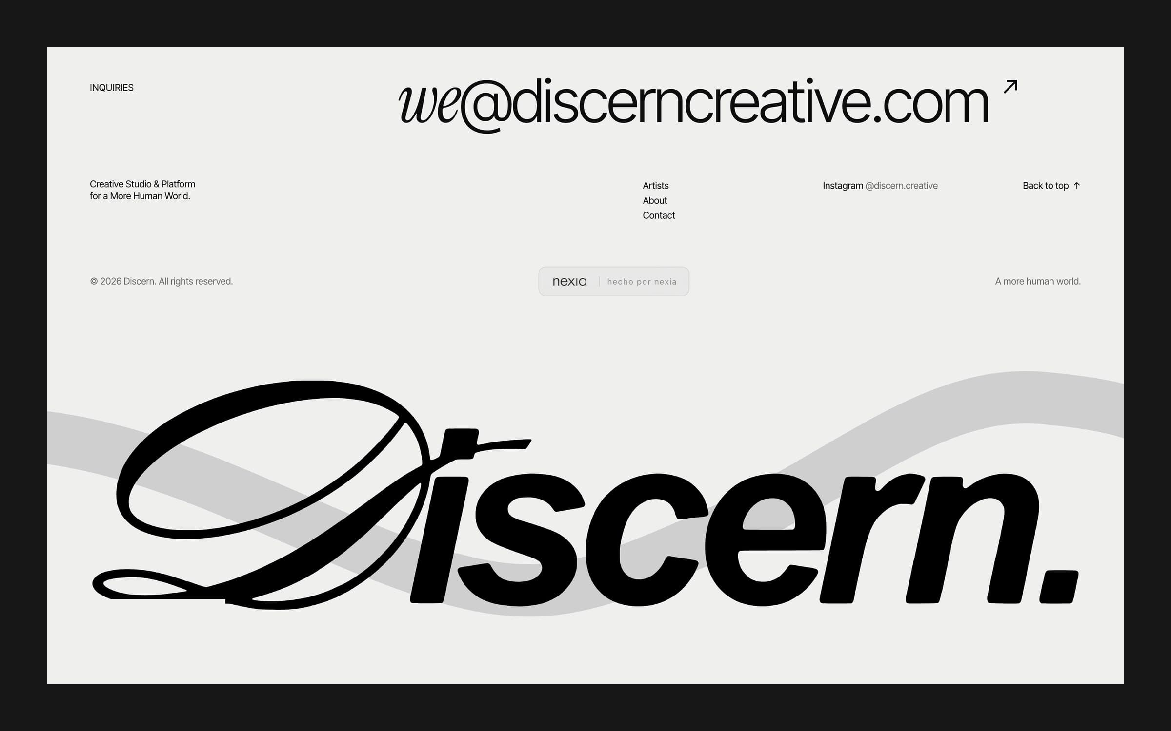 Footer of the Discern site: contact line, small links and a giant Discern wordmark over a grey wave