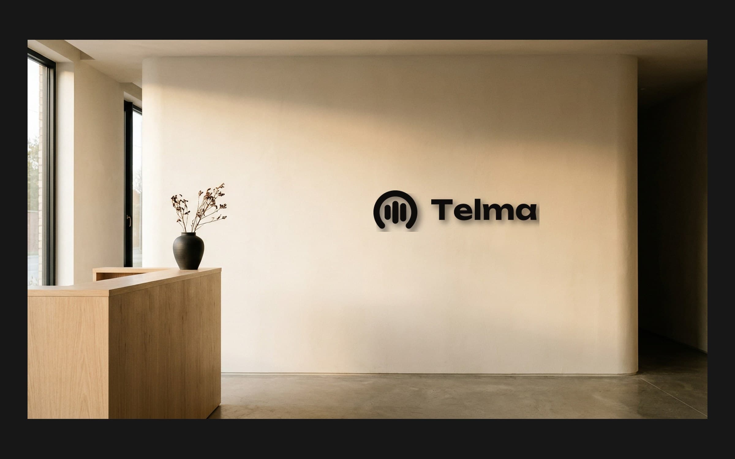 Mockup of the Telma logo mounted on a light reception wall